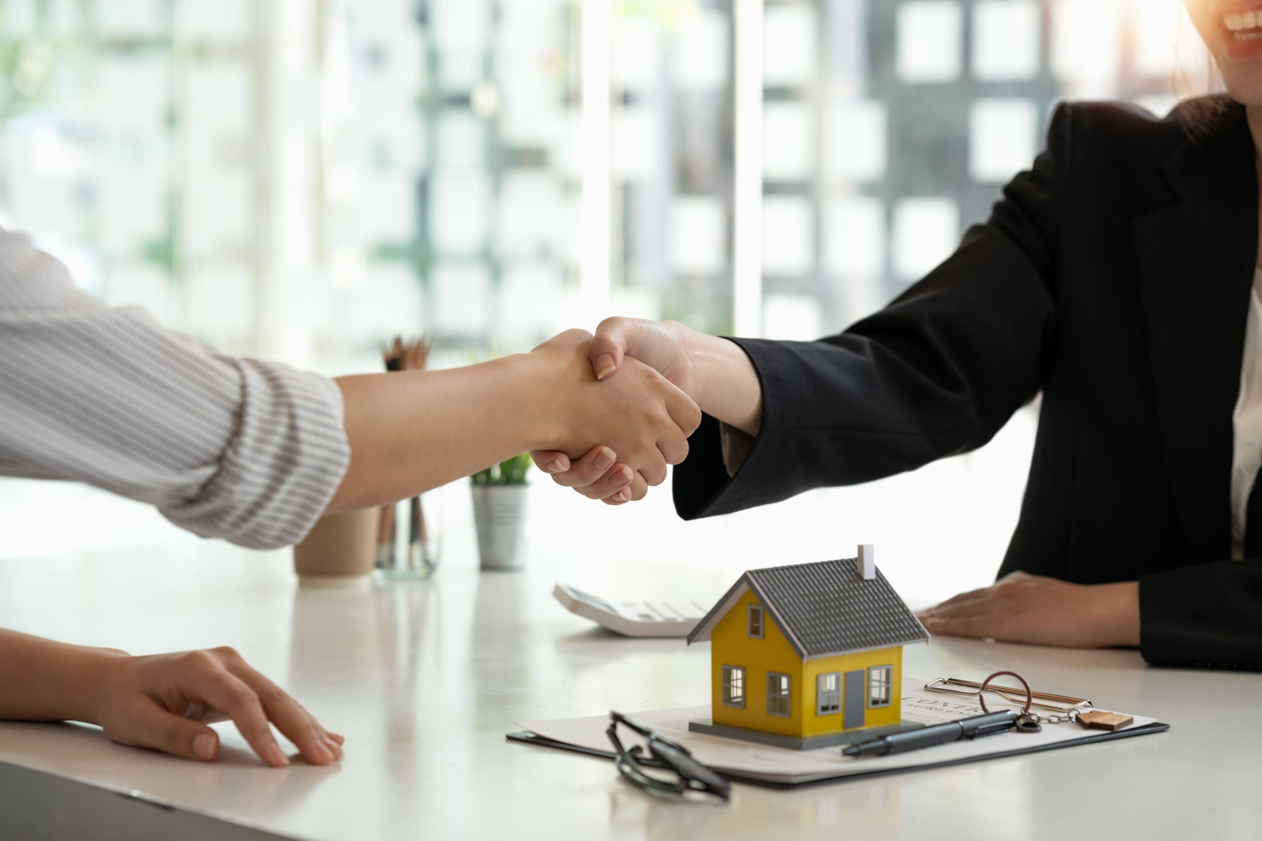 real-estate-broker-customer-shaking-hands-after-signing-contract-real-estate-home-loan-insurance-concept